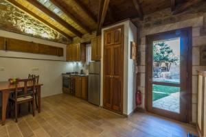 a kitchen with a table and a door to a dining room at Stone House Messinia in Málta