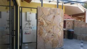 a stone wall in a room with a kitchen at NUESTRA CASA - OUR HOME Cuenca by A2CC in Ricaurte +73 photos