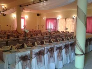 a row of tables and chairs in a banquet hall at Platán Panzió in Nagyszénás