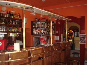 a bar with a lot of bottles of alcohol at Platán Panzió in Nagyszénás