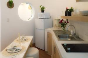 a kitchen with a sink and a white refrigerator at Very Special Place Apto in Guatemala