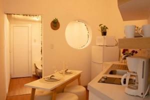 a kitchen with a table and a white refrigerator at Very Special Place Apto in Guatemala