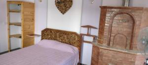 a bedroom with a bed and a brick fireplace at La Pergola, Sauce Monte Hermoso in Monte Hermoso