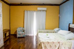 Cama ou camas em um quarto em Pousada Terraço Penedo