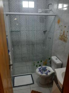 a bathroom with a shower with a toilet and a sink at Casa do Jaime in Itapoa