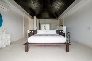 a bedroom with a large white bed in a room at SulMare at Taylor Bay Luxury villas in Providenciales
