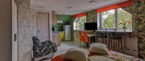 a bedroom with a bed and a kitchen with a counter at Central Riverside Apartments in Jēkabpils