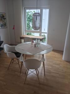a dining table and chairs in a living room at Ferien am Wasser in Wiesbaden