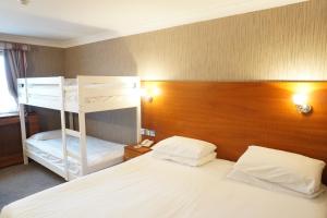 a bedroom with two bunk beds in a room at The Park Hotel in Liverpool