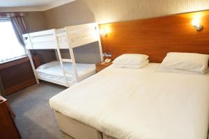 a bedroom with a bed and a bunk bed at The Park Hotel in Liverpool