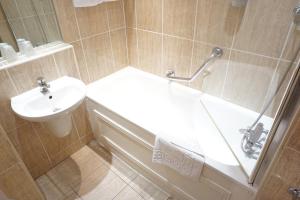 a bathroom with a sink and a toilet and a shower at The Park Hotel in Liverpool +30 photos