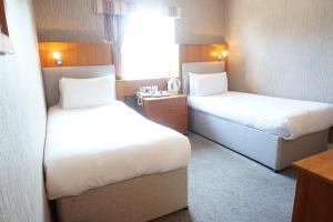 a hotel room with two beds and a window at The Park Hotel in Liverpool