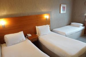 a hotel room with two beds and a telephone at The Park Hotel in Liverpool