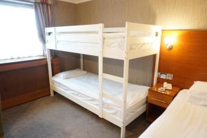 a bedroom with two bunk beds in a room at The Park Hotel in Liverpool