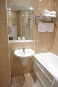 a bathroom with a sink and a shower with a mirror at The Park Hotel in Liverpool