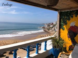 a balcony with a view of the beach at L'Auberge Taghazout in Taghazout