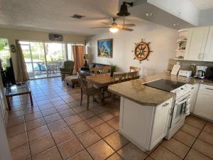 a kitchen and living room with a table and a dining room at LICENSED MGR - 2/2 VILLA - OCEANFRONT BEACH RESORT - SALTWATER LAGOON & MARINA! in Key Largo