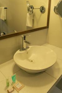 a white sink in a bathroom with a mirror at VO&acute;E in San Crist&oacute;bal de Las Casas