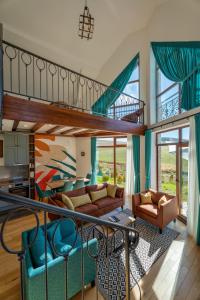 a living room with a couch and a staircase at Vila S6 in Zlatibor