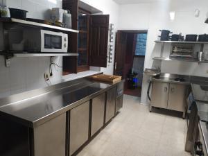 a kitchen with a sink and a microwave at Valdemarin Rural in Orcera