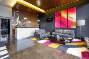 a lobby with a waiting room with chairs and a table at The View Hotel by Covalia in San Luis Potosí