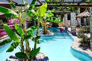 a pool with a bunch of trees and plants at Flat in Bali with Balcony in Balíon +21 photos