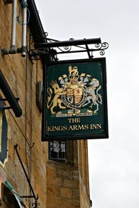 a sign hanging on the side of a building at The Kings Arms Inn in Yeovil