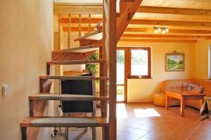 a living room with a spiral staircase in a house at holiday home, Wilkasy in Wilkasy