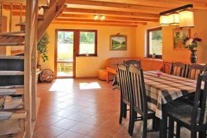 a dining room with a table and a couch at holiday home, Wilkasy in Wilkasy