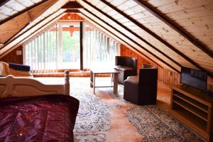 a room with a couch and a table in a house at holiday home, Junoszyno in Junoszyno