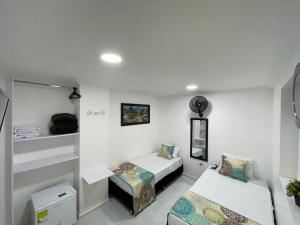 a room with two beds and a bed and a couch at Hotel Eterna Primavera in Medellín +100 photos