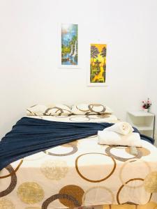 a bedroom with a bed with two paintings on the wall at Pousada Center in Barreirinhas