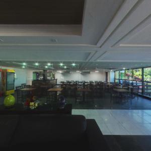 a dining room with tables and chairs in a building at Flat Mar do Cabo Branco Residence in João Pessoa