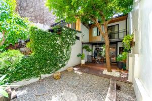 an exterior view of a house with a tree at Tree House in Tainan