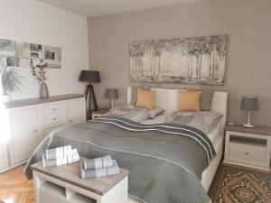 a bedroom with a bed and a painting on the wall at Apartment Andy in Medvode