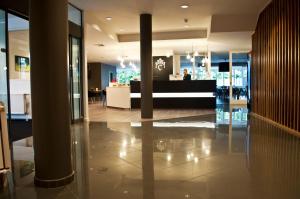 a lobby of a building with a store at Hotel Corsendonk Viane in Turnhout