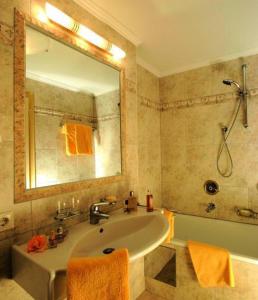 a bathroom with a sink and a mirror and a shower at Pension Almrausch in Neustift im Stubaital