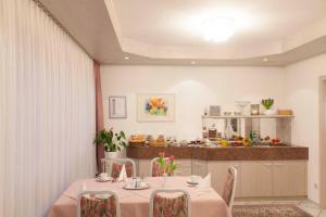 a dining room with a table and a kitchen at Hotel Apart in Reichenbach an der Fils