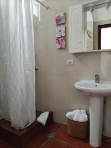 a bathroom with a sink and a shower curtain at Casa del Cu bano B- Biosphere Reserve in Santa Cruz de Tenerife +20 photos