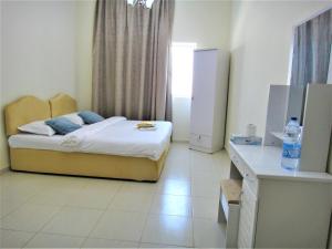 Abu Hail Star Residence - Home Stay客房内的一张或多张床位