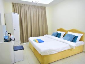 מיטה או מיטות בחדר ב-Abu Hail Star Residence - Home Stay