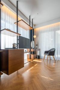 a living room with a table and a chair at Moncafe Boutique Hotel & SPA Tirana in Tirana