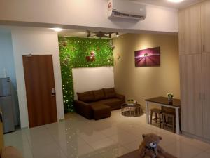 a living room with a couch and christmas decorations at #6 Summer Studio - One South in Seri Kembangan