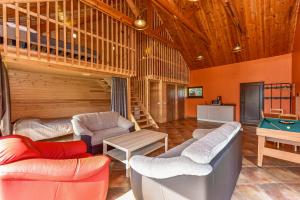a living room with couches and a pool table at Spacious Loft in the Nature in Molėtai