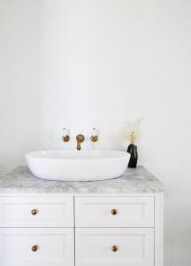 a white sink on a counter in a bathroom at The Cape at Wategos Pool Pavilion in Byron Bay