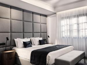 a bedroom with a large bed and a large window at Vanoro Hotel in Thessaloniki