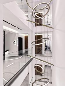 a spiral staircase in a lobby with glass shelves at Vanoro Hotel in Thessaloniki