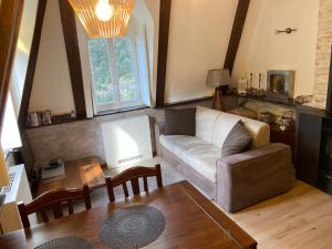 a living room with a couch and a table at Castle - A Magic Retreat in Fobello