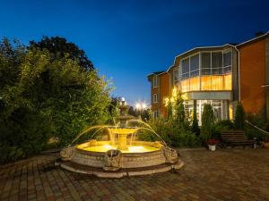 a fountain in a courtyard in front of a building at Park Hotel in Khmelnytskyi