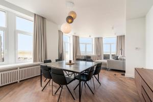 a dining room with a table and chairs at Residence Palace Style app in a unique building in Zeebrugge